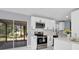 Bright kitchen with white cabinets, stainless steel appliances and quartz countertops at 22219 Catherine Ave, Port Charlotte, FL 33952