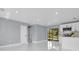 Bright living room featuring white tile floors, recessed lighting, and sliding glass doors to the back at 22219 Catherine Ave, Port Charlotte, FL 33952