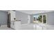 Bright living area featuring white tile floors and a breakfast bar overlooking the window view at 22219 Catherine Ave, Port Charlotte, FL 33952