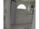 Bathroom with a large tub with shower, unique window and vanity mirror at 23167 Turnbull Ave, Port Charlotte, FL 33954