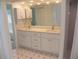 Bright bathroom features dual sinks, quartz countertops, and sleek white cabinetry at 23167 Turnbull Ave, Port Charlotte, FL 33954