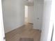 Bedroom with hardwood floors, fresh paint and two doors, one leading into the hallway at 23167 Turnbull Ave, Port Charlotte, FL 33954