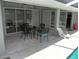 Outdoor lanai with an outdoor dining set and pool access at 23167 Turnbull Ave, Port Charlotte, FL 33954