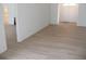 Spacious living room with hardwood floors, fresh paint and a view of the front door at 23167 Turnbull Ave, Port Charlotte, FL 33954