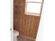 Unique powder room with wood-paneled walls and a bright window at 23167 Turnbull Ave, Port Charlotte, FL 33954