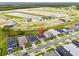 A neighborhood aerial view highlighting modern homes, lush green spaces, and a tranquil pond, ideal for peaceful living at 2477 Gabel Oak Dr, North Port, FL 34289