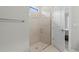 Modern tiled shower with glass door and a view of the main bedroom at 2477 Gabel Oak Dr, North Port, FL 34289