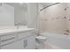 Bright bathroom with modern fixtures, neutral tile and a shower-tub combo at 2477 Gabel Oak Dr, North Port, FL 34289