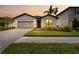 Charming single-story home featuring a manicured lawn, paved driveway, and inviting front entrance at 2477 Gabel Oak Dr, North Port, FL 34289
