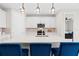 Stylish kitchen with a center island, pendant lighting, and a view into an adjacent bedroom at 2477 Gabel Oak Dr, North Port, FL 34289