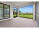 Covered lanai with brick flooring and a view of the green backyard at 2477 Gabel Oak Dr, North Port, FL 34289