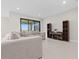 Cozy living room featuring a comfortable sofa, tile flooring, and stylish wooden shelving at 2477 Gabel Oak Dr, North Port, FL 34289