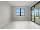 Bright living room features a sliding glass door with backyard views at 2477 Gabel Oak Dr, North Port, FL 34289