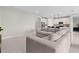 Open living space with a large sofa and an adjacent kitchen, both featuring tile flooring and neutral walls at 2477 Gabel Oak Dr, North Port, FL 34289