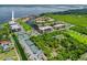 Expansive aerial view showcasing waterfront condos, tennis courts, lush landscaping, and serene canal access at 25188 Marion Ave # 45, Punta Gorda, FL 33950