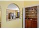 Charming wet bar area with custom cabinets, shelving, and a pass-through window to the dining room at 25188 Marion Ave # 45, Punta Gorda, FL 33950