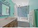 Elegant bathroom featuring a soaking tub with decorative blue mosaic tiles and a stylish vanity at 25188 Marion Ave # 45, Punta Gorda, FL 33950