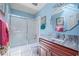 Well-lit bathroom featuring a shower-tub combo with glass doors and a vanity with a marble countertop at 25188 Marion Ave # 45, Punta Gorda, FL 33950