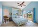 Bright bedroom featuring a built-in Murphy bed and sliding glass door with view to the outdoor deck at 25188 Marion Ave # 45, Punta Gorda, FL 33950