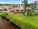 Waterfront home boasts a spacious deck, well-maintained lawn, and picturesque water views for tranquil outdoor living at 25188 Marion Ave # 45, Punta Gorda, FL 33950