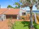 Beautiful waterfront home with a brown garage door, lush landscaping, and a wooden deck overlooking the water at 25188 Marion Ave # 45, Punta Gorda, FL 33950