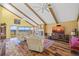 Inviting living room featuring vaulted ceilings, exposed beams, and stunning waterfront views at 25188 Marion Ave # 45, Punta Gorda, FL 33950