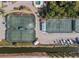 Aerial view highlighting well-maintained tennis courts and boat storage in a beautiful waterfront community at 25188 Marion Ave # 45, Punta Gorda, FL 33950