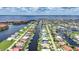 Overhead view of a home surrounded by canals and other homes near a large body of water at 2815 Coral Way, Punta Gorda, FL 33950