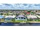 An aerial shot of a home with a pool and canal access, nestled in a vibrant neighborhood at 2815 Coral Way, Punta Gorda, FL 33950