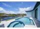 Gorgeous backyard pool and spa overlooking the canal with lush greenery and an idyllic waterfront setting at 2815 Coral Way, Punta Gorda, FL 33950