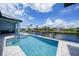Stunning backyard pool and spa overlooking the serene canal, creating a perfect waterfront oasis for relaxation and entertainment at 2815 Coral Way, Punta Gorda, FL 33950