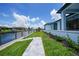 A beautiful backyard featuring a serene canal view, lush greenery, and a charming stone walkway at 2815 Coral Way, Punta Gorda, FL 33950