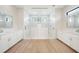 Luxurious primary bathroom with double vanities, and a large glass enclosed shower at 2815 Coral Way, Punta Gorda, FL 33950
