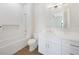 Bright and modern bathroom with tub and shower boasts updated tile and vanity at 2815 Coral Way, Punta Gorda, FL 33950