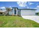 A home featuring a three-car garage, meticulous landscaping, and a contemporary entrance at 2815 Coral Way, Punta Gorda, FL 33950
