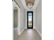 Bright entryway with a modern light fixture, contemporary door, and elegant flooring at 2815 Coral Way, Punta Gorda, FL 33950