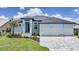 Charming blue single-Gathering home featuring a well-manicured lawn, beautiful flowerbeds, and a large two-car garage at 2815 Coral Way, Punta Gorda, FL 33950