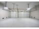 Spacious two-car garage featuring large doors and epoxy flooring at 2815 Coral Way, Punta Gorda, FL 33950