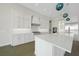 Bright modern kitchen boasts white cabinets, stainless-steel appliances, and a large center island at 2815 Coral Way, Punta Gorda, FL 33950