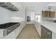 Bright modern kitchen features white cabinets, stainless-steel appliances, and a gas range at 2815 Coral Way, Punta Gorda, FL 33950