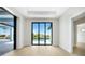 Bright living room with sliding glass doors leading to a beautiful pool and waterfront view at 2815 Coral Way, Punta Gorda, FL 33950