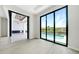 Bright living room boasts floor-to-ceiling windows and open access to the outdoor kitchen and pool area at 2815 Coral Way, Punta Gorda, FL 33950