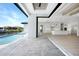 Open floorplan with access to outdoor pool and kitchen area with sleek white cabinetry and modern appliances at 2815 Coral Way, Punta Gorda, FL 33950