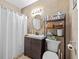Neutral toned bathroom featuring a shower/tub combo with tile surround, vanity with storage and shelving for toiletries at 3197 Normandy Dr, Port Charlotte, FL 33952