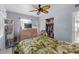 Light-filled bedroom with a leafy comforter, ceiling fan, and closet with organized storage at 3197 Normandy Dr, Port Charlotte, FL 33952