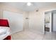 Bedroom showcasing a neutral palette, closet with bi-fold doors, and a peek into the kitchen at 3197 Normandy Dr, Port Charlotte, FL 33952