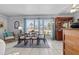A brightly lit dining room with a ceiling fan, a dining table, and an antique display cabinet with natural light at 3197 Normandy Dr, Port Charlotte, FL 33952