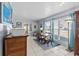 A bright dining room with natural light, tile flooring, and cool toned walls and curtains to match the floor rug at 3197 Normandy Dr, Port Charlotte, FL 33952