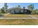 Charming single-story home featuring a covered carport, screened porch, and a well-maintained front lawn at 3197 Normandy Dr, Port Charlotte, FL 33952