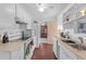A bright kitchen with white appliances and lots of storage with white cabinets and wood style floors at 3197 Normandy Dr, Port Charlotte, FL 33952